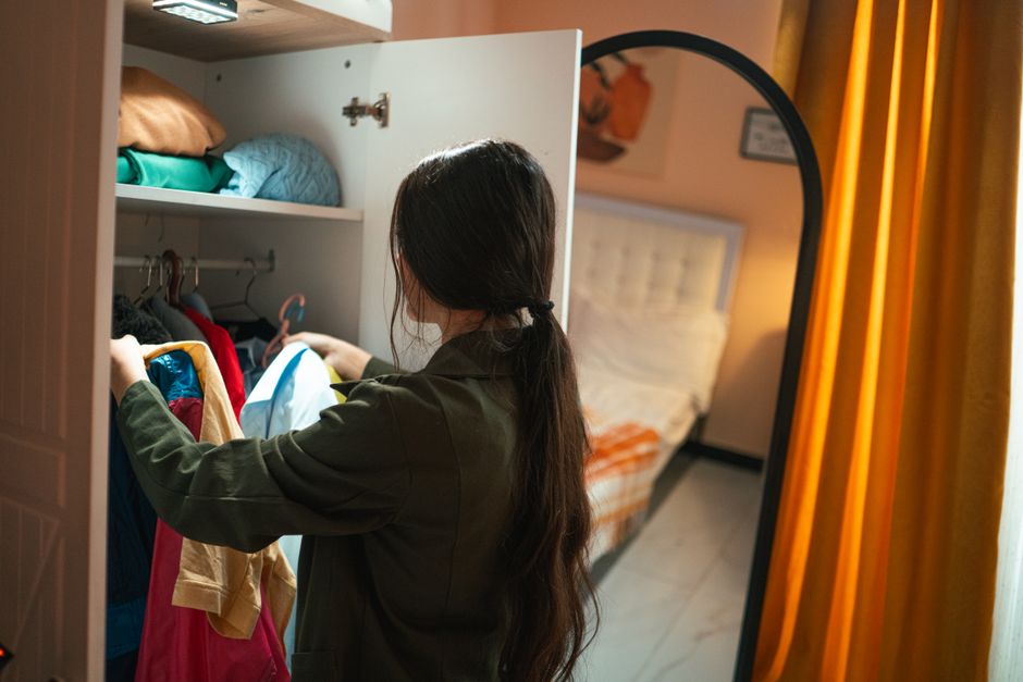 Woman organizing a beautifully designed custom clothes closet