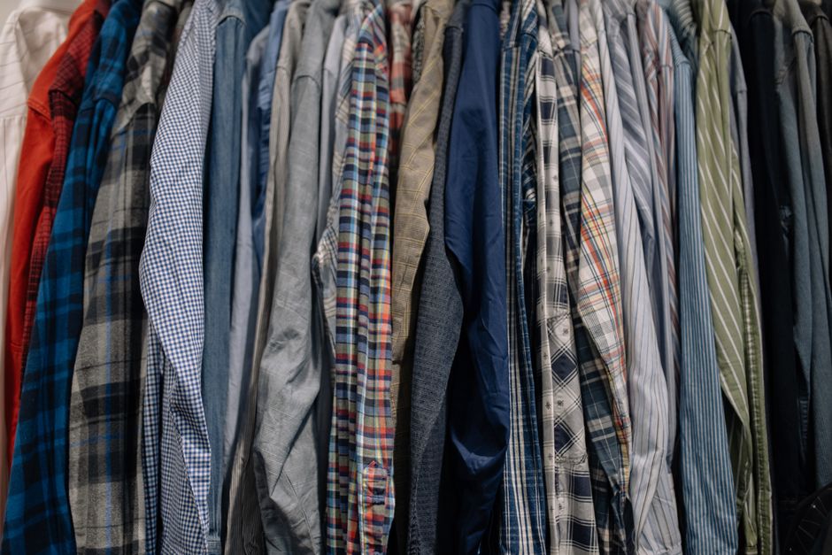Shirts neatly hanging in a custom reach-in wardrobe system